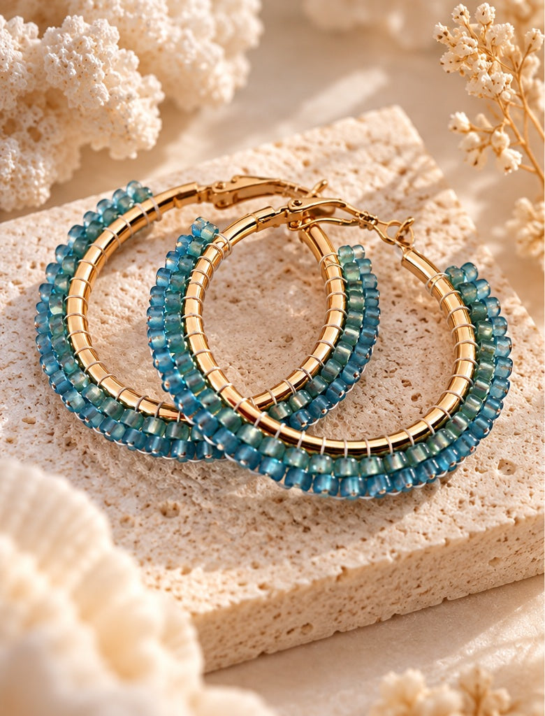 Azure Tide earrings styled on coastal stone