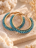 Azure Tide earrings styled on coastal stone